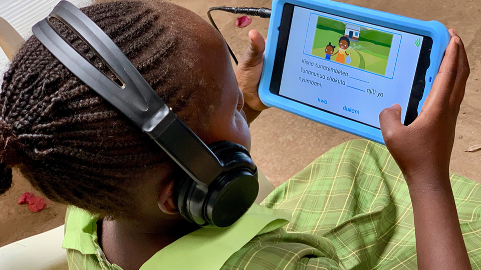 Girl with headphones uses onebillion tablet computer
